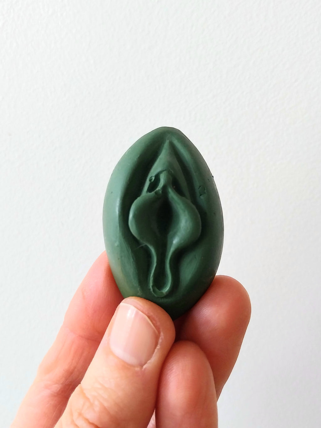 Crayon de subversion en cire végétale et pigments naturels VULVA NATURALIS, en forme de vulve, sapin, vue de face.